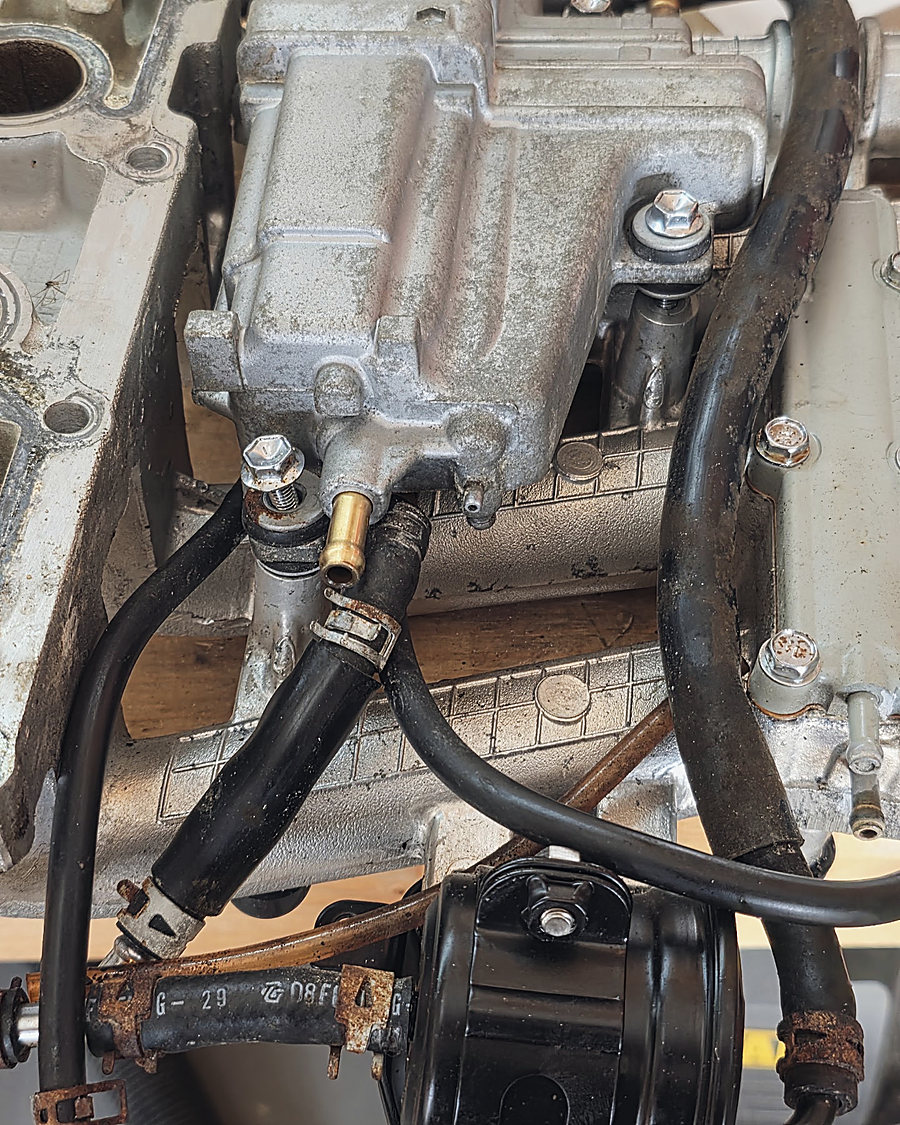 A powerhead block on the bench with the intake off