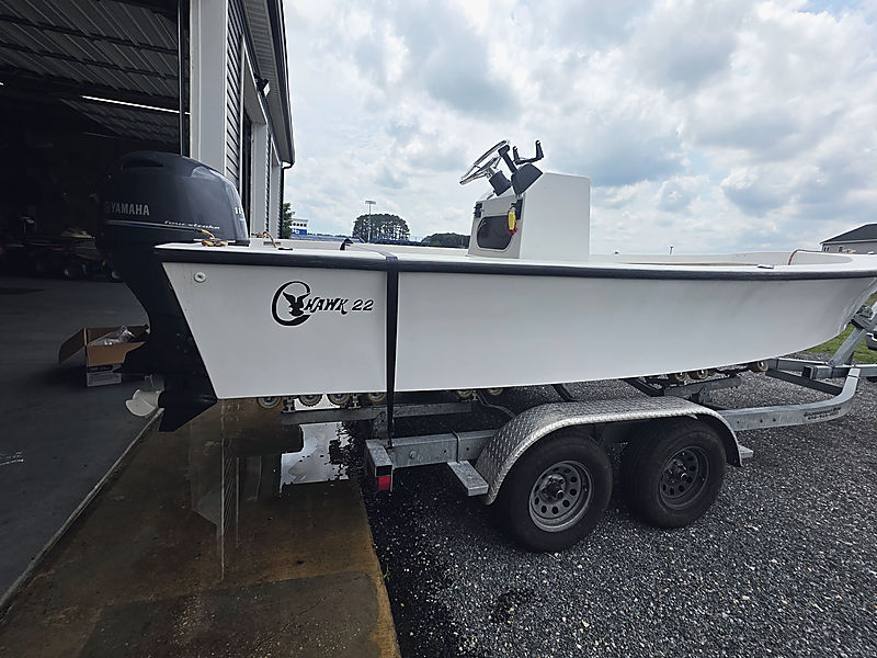 A Hawk 22 center console on its trailer outside the shop