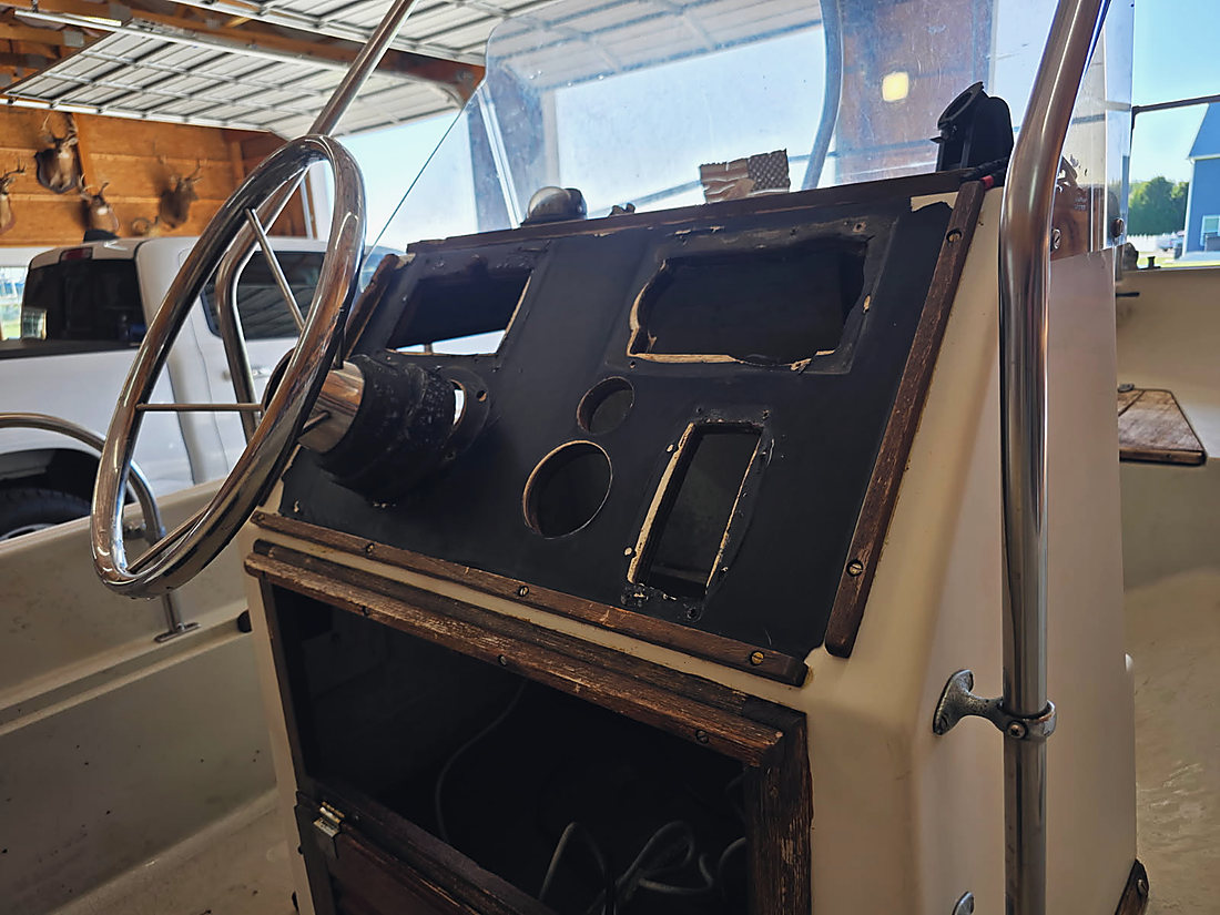 The center console stripped back to the panel, the gauge and switch holes empty