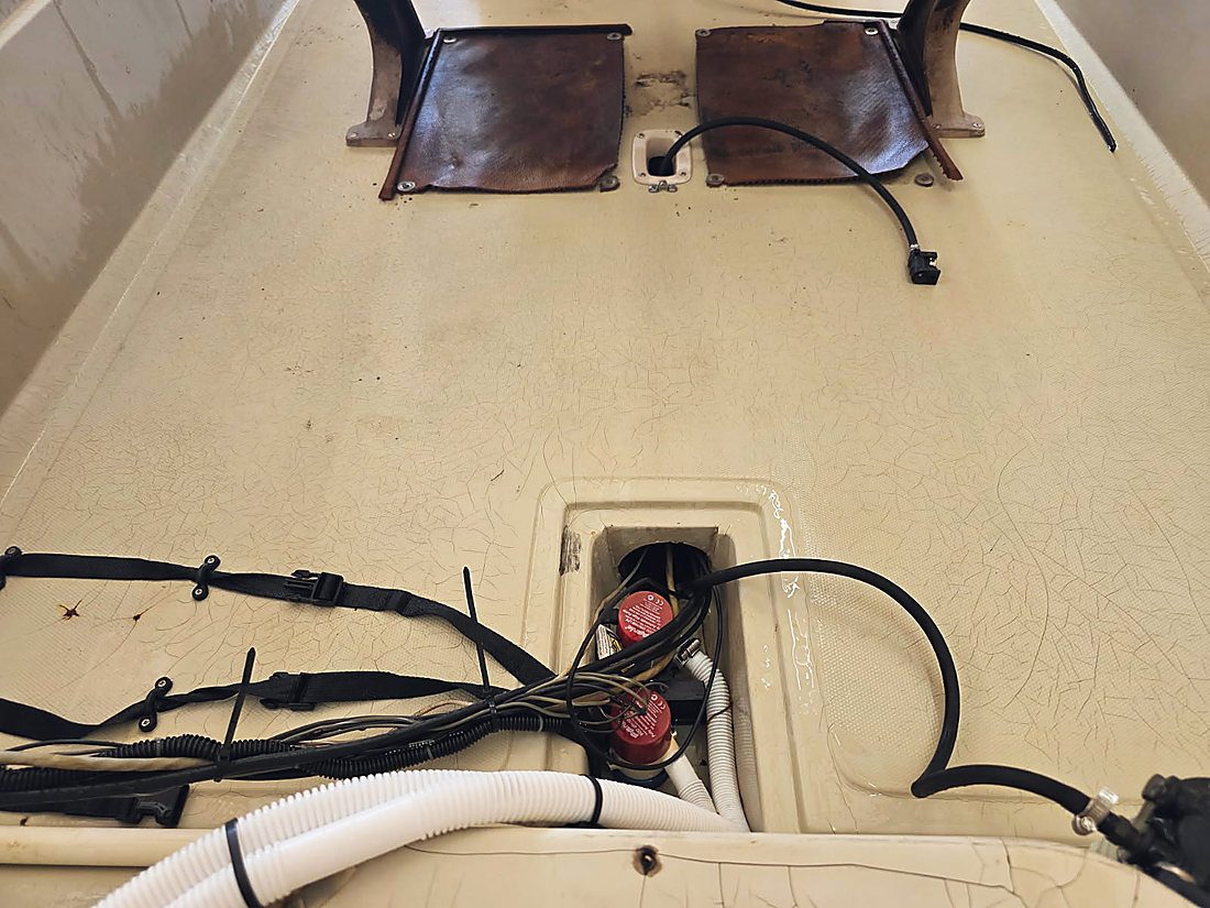 Wiring and rigging hose run down through a hatch in the deck